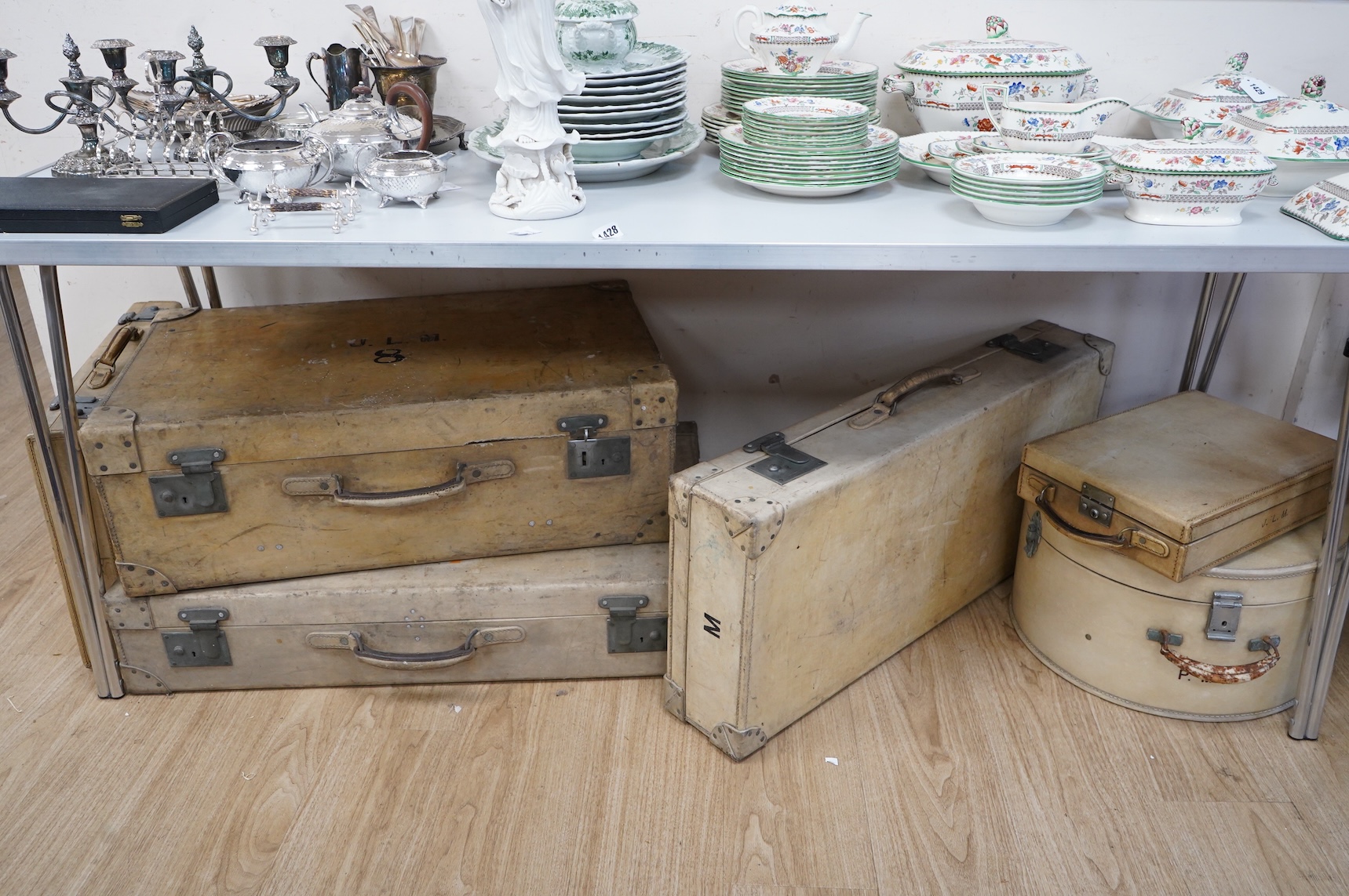 A collection of luggage comprising four vintage trunks and a hat box